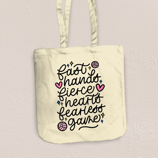 Tote bag with motivational quote and volleyball graphics on a light background